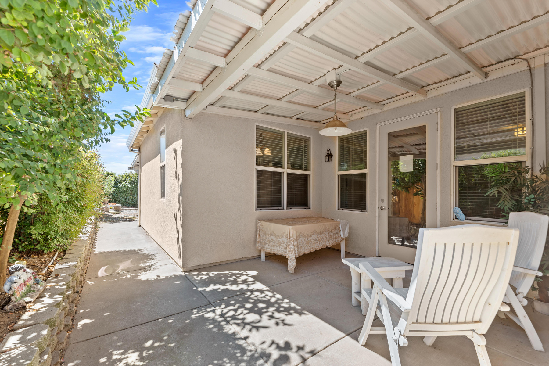 The shaded backyard patio and lawn at Millport Villas