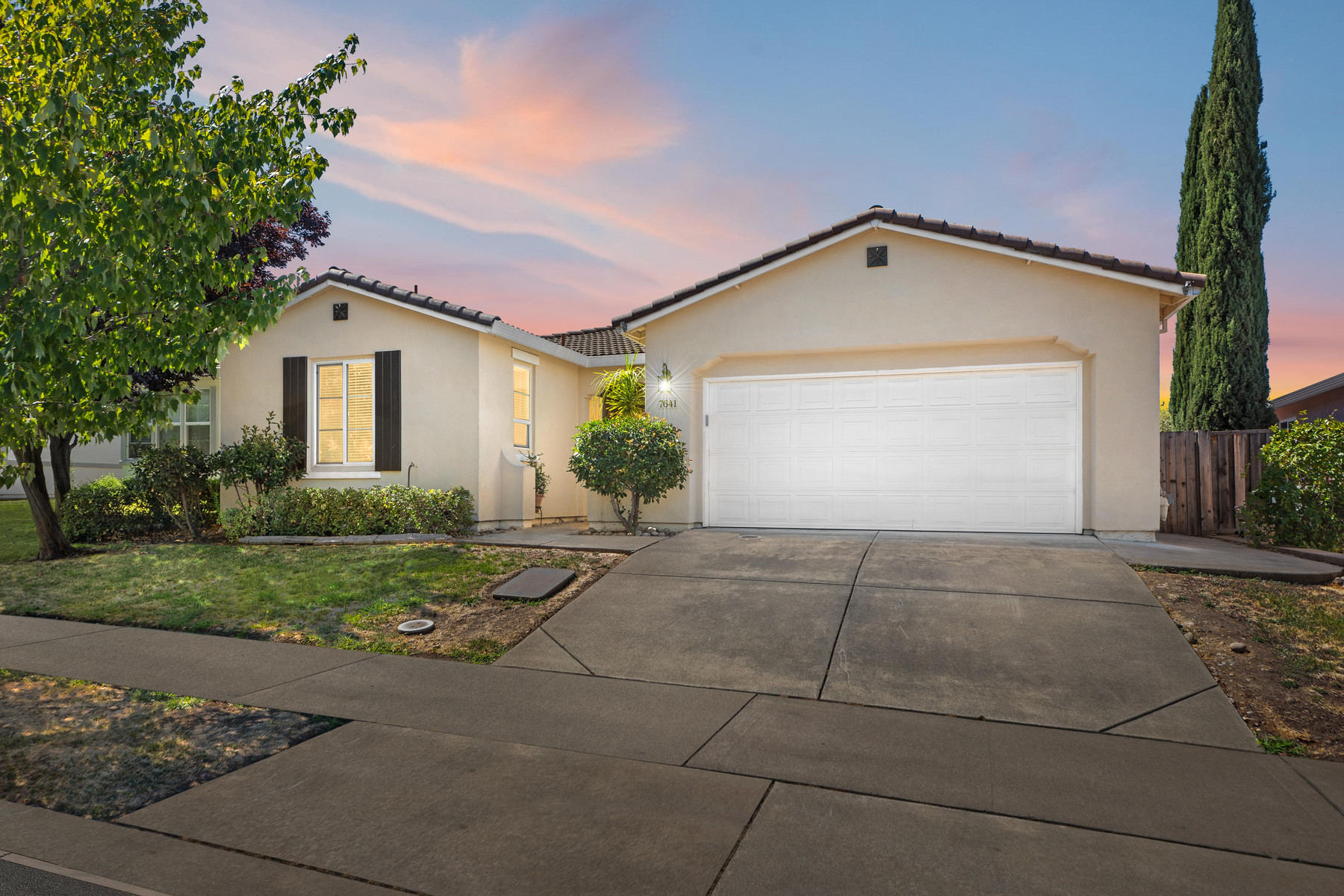 The Millport Villas home at dusk, a single-storey residence on a quiet Roseville street
